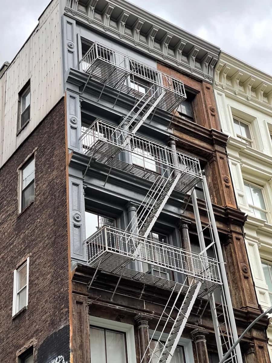 Cast iron facade in SoHo with fire escapes, painted and restored
