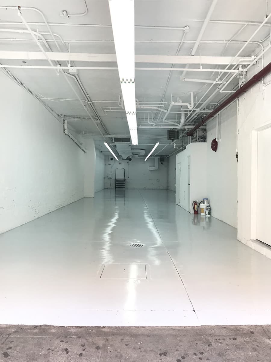 Long commercial floor with a fresh glossy white coating